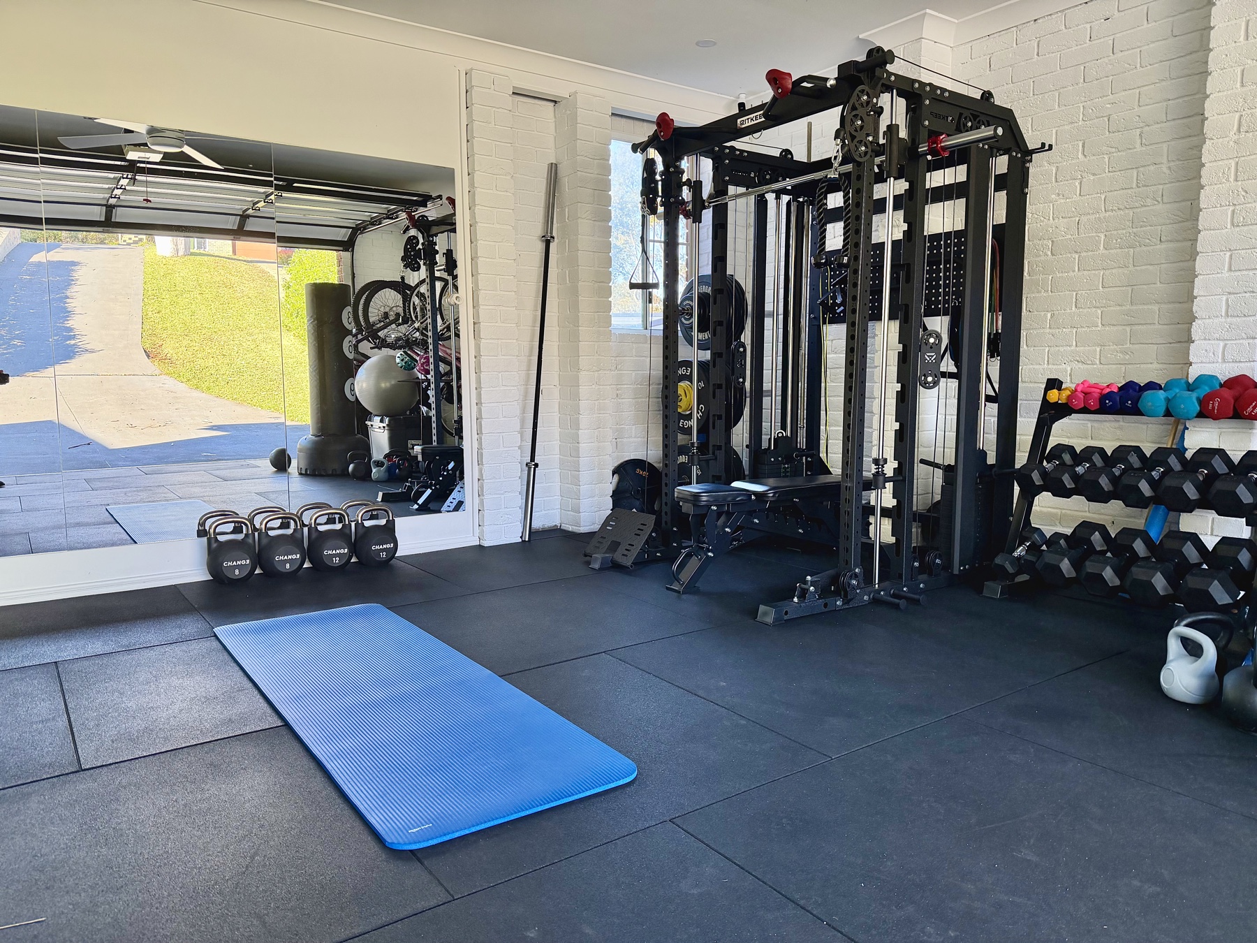 Yellow Rock PT private studio with cable machine, dumbbells, kettlebells, mirrors and a blue exercise mat